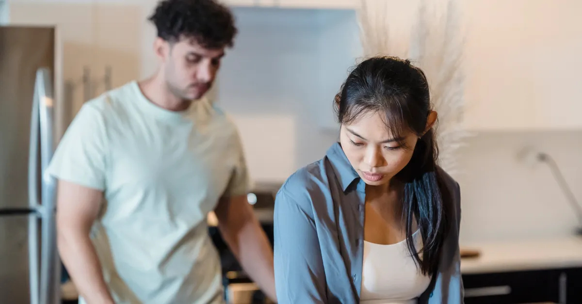 A couple having a serious conversation in a modern kitchen
