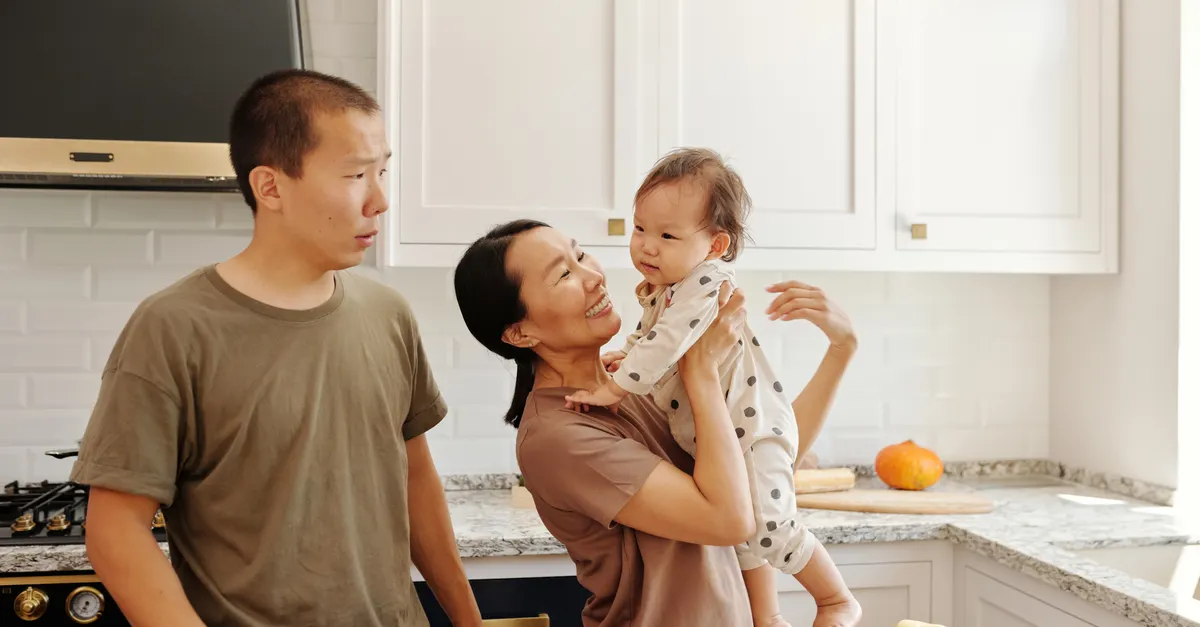 A cheerful family bonding together in a warm kitchen.