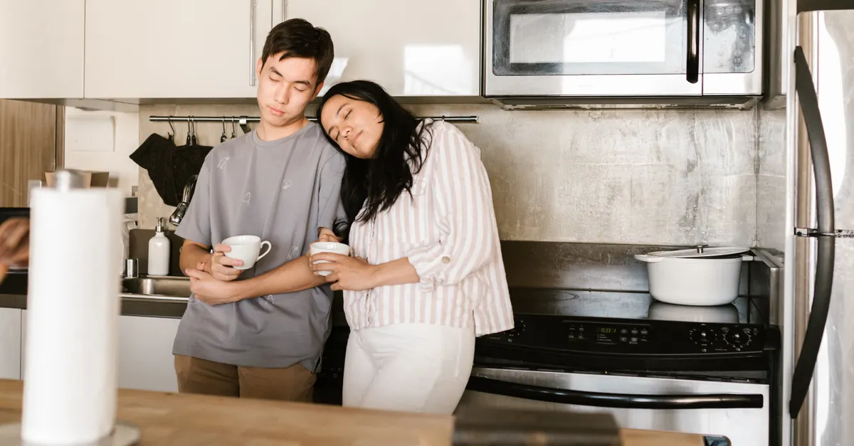 A couple enjoys a relaxing morning with coffee in their kitchen.